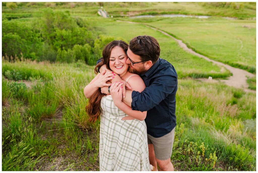 Dustin & Kristyn - Wascana Trails Engagement - 12 - Groom wraps up his beloved overlooking the valley