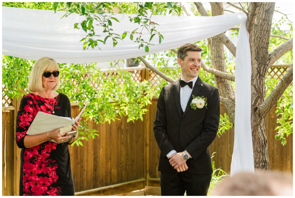 Charlie & Brittany - Regina Wedding - 08- Groom watches bride enter