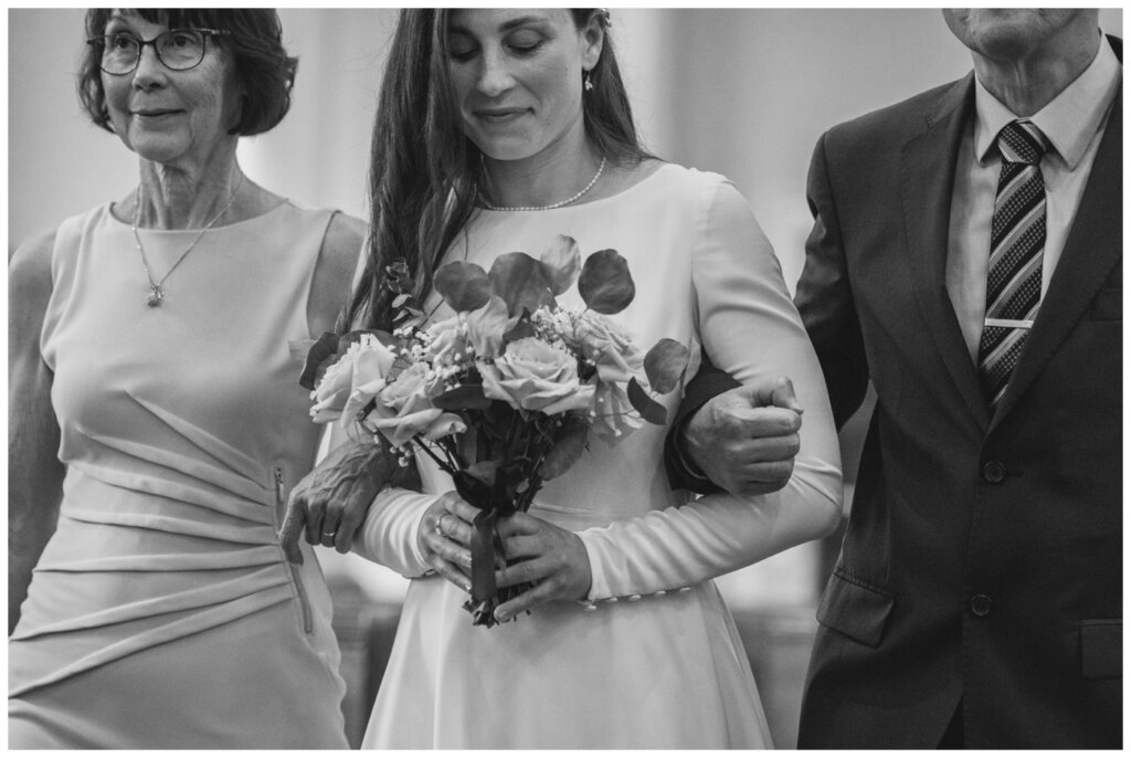 Remi & Celine - Regina Wedding - Holy Rosary Cathedral - 03- Bride carries bouquet of blush roses