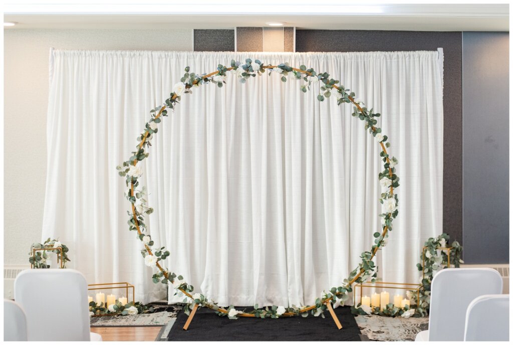 Darren & Amber - Regina Wedding - Summer Wedding 2024 - 10 - The Atlas Hotel - Gold circle backdrop with floral decor