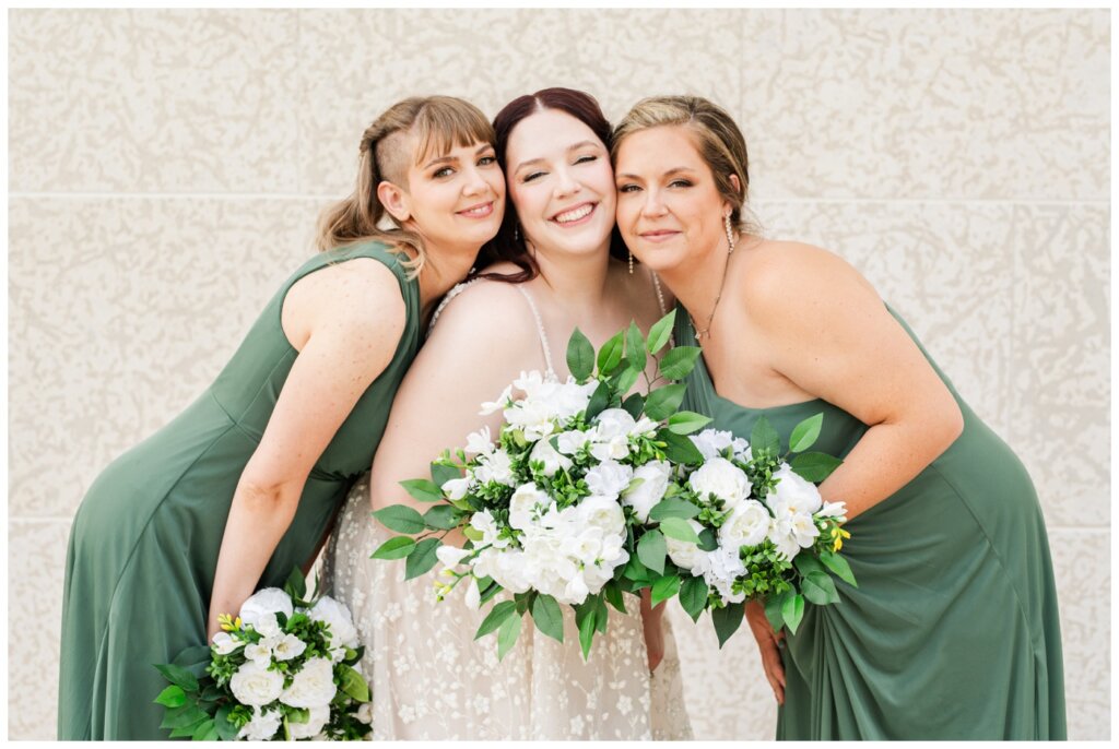 Darren & Amber - Regina Wedding - Summer Wedding 2024 - 16 - TC Douglas Building - Bridesmaids cheek to cheek with the bride