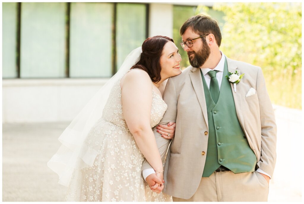 Darren & Amber - Regina Wedding - Summer Wedding 2024 - 19 - TC Douglas Building - Bride & groom hold hands