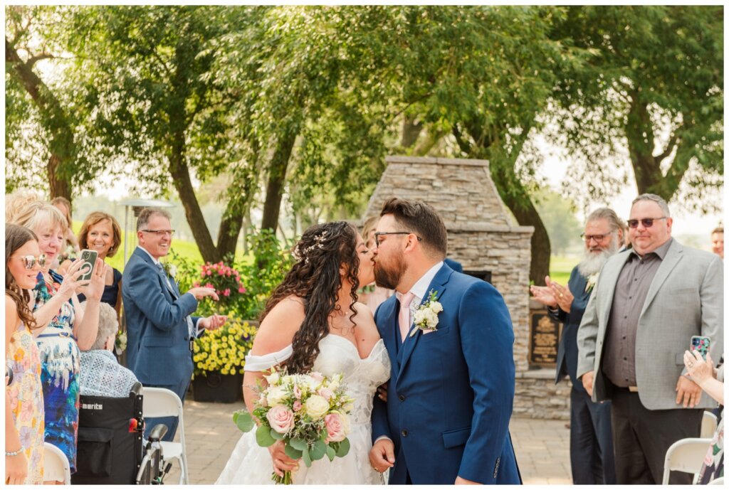 Dustin & Kristyn - Regina Wedding - 11 - Wascana Country Club - Bride & Groom pause for a kiss as they exit