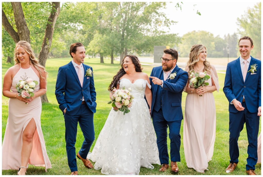 Dustin & Kristyn - Regina Wedding - 13 - University of Regina - Bridal party walks laughing