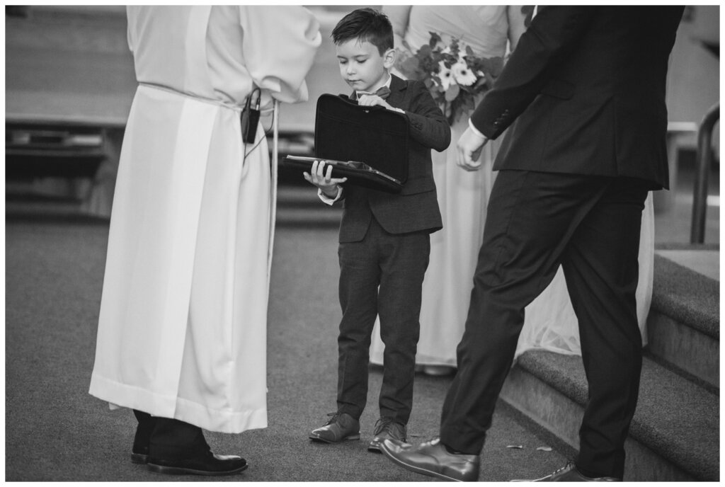 Evan & Melissa - Regina Wedding - Holy Child Parish - 17 - Ring bearer opens his briefcase