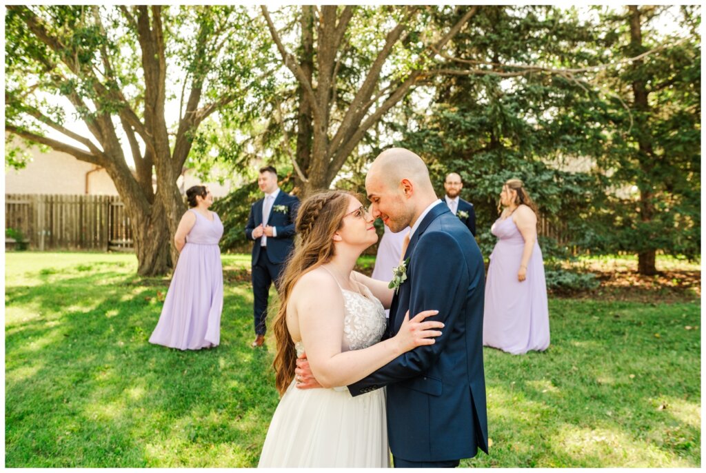 Evan & Melissa - Regina Wedding - Howell Park - 21 - Bride and groom stand in front of bridal party