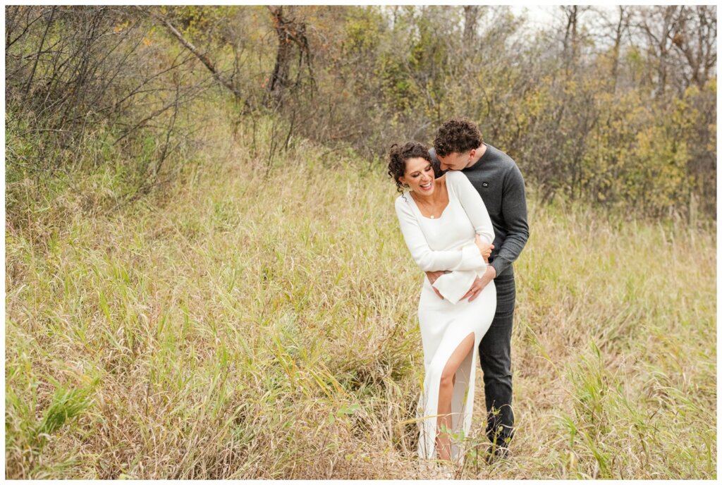 Blayde & Hanna - Regina Engagement Session - 04 - Wascana Trails - Groom nuzzles into his fiancee