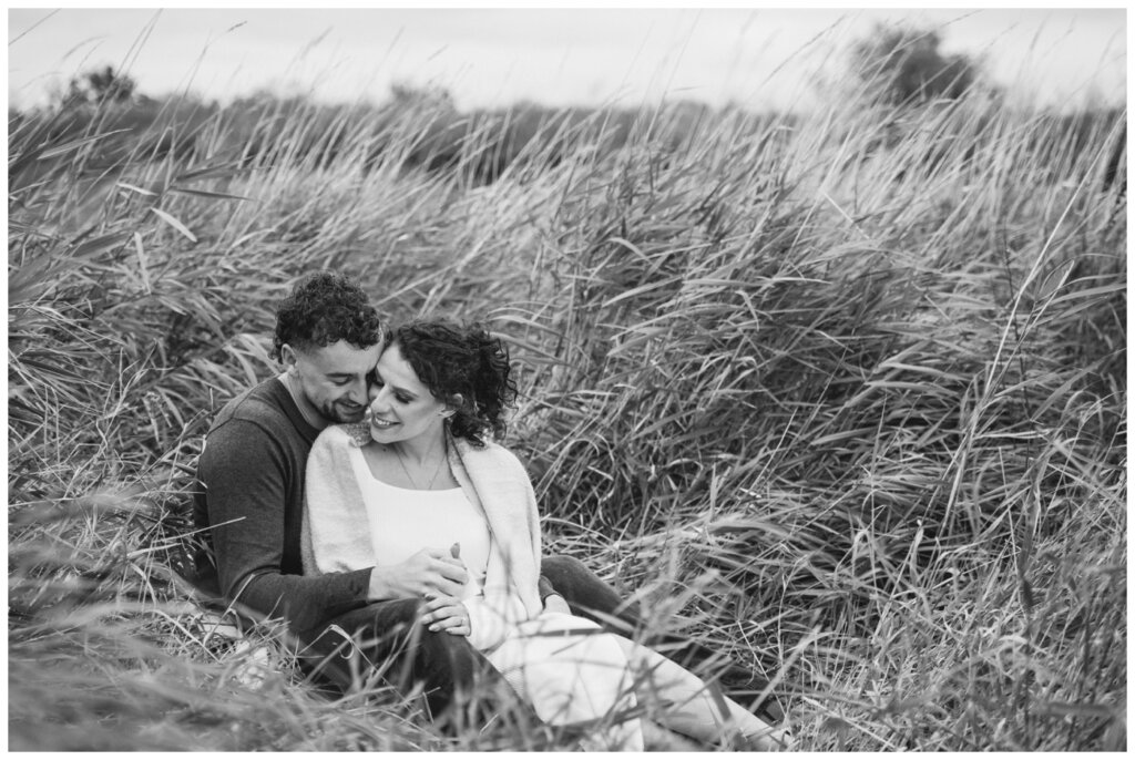 Blayde & Hanna - Regina Engagement Session - 09 - Wascana Trails - Couple have an intimate moment in the grass