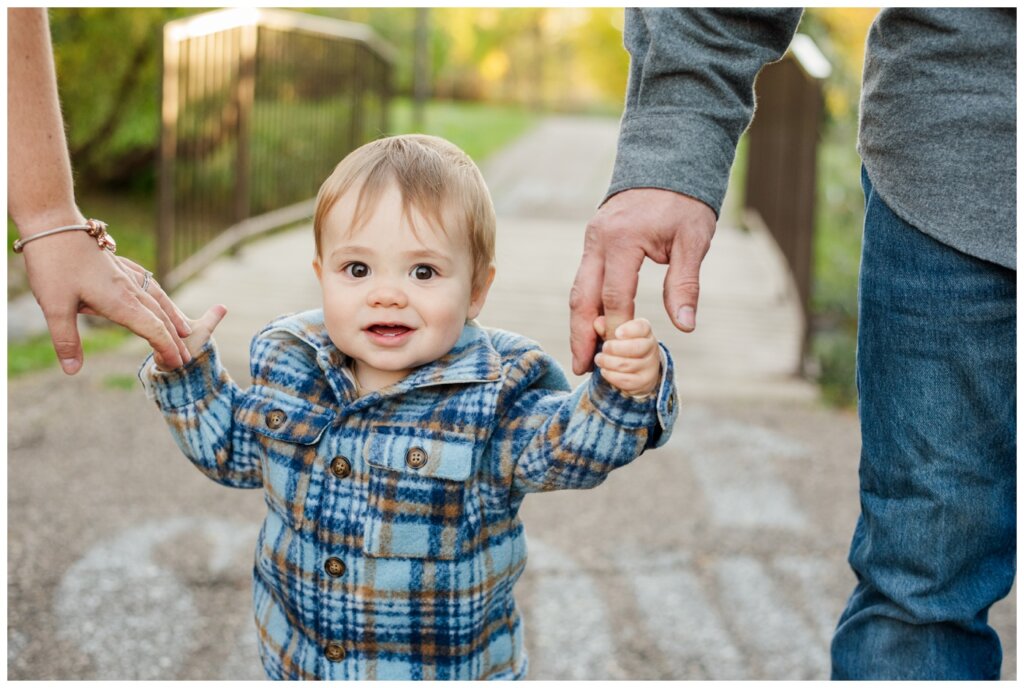 Filby Family 2024 - Regina Family Photography - 04 - Wascana View Park - Little boy smiles in a plaid shacket