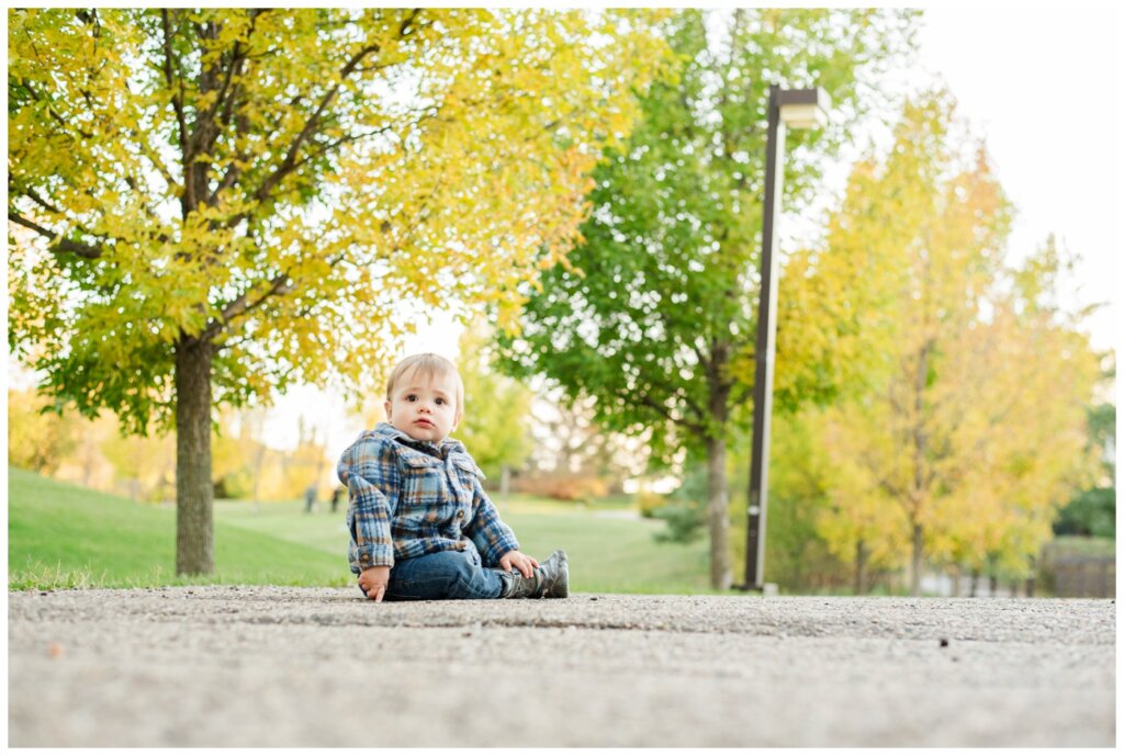 Filby Family 2024 - Regina Family Photography - 06 - Wascana View Park - Little boy sits on path