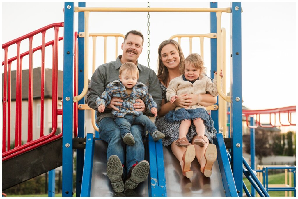 Filby Family 2024 - Regina Family Photography - 13 - Wascana View Park - Family sits on slide