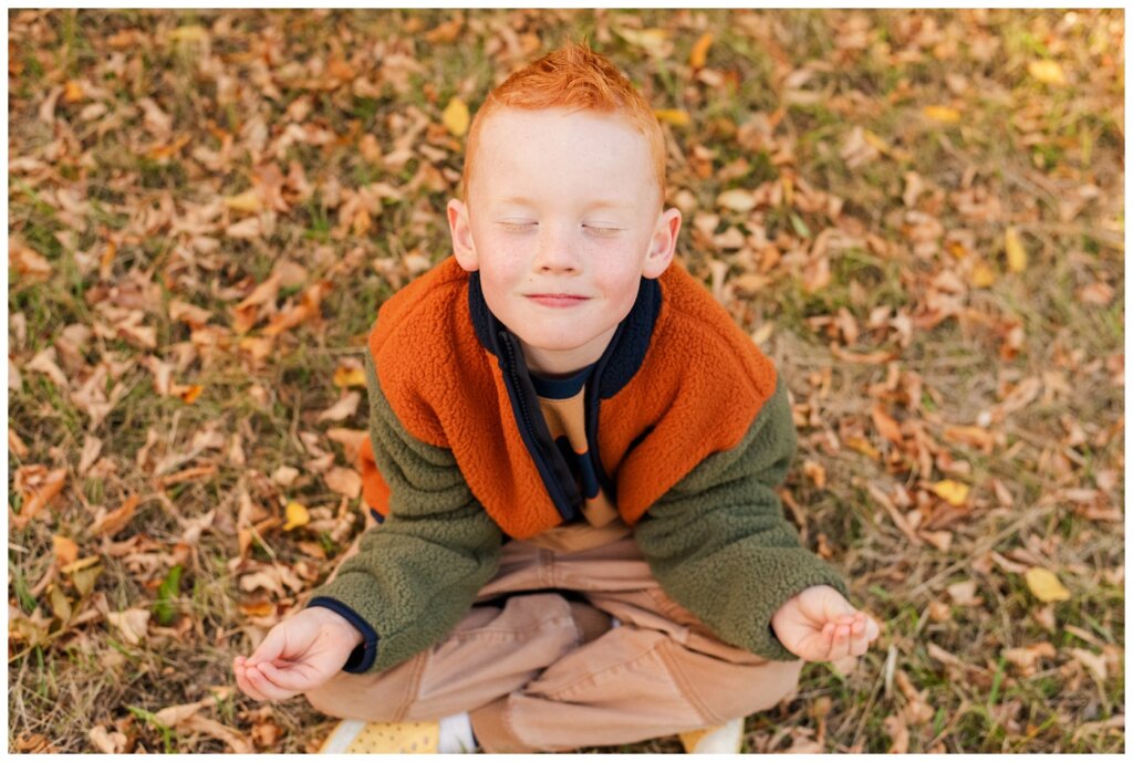 Pelletier Family 2024 - Saskatchewan Science Centre -06 - Little boy sits down to meditate