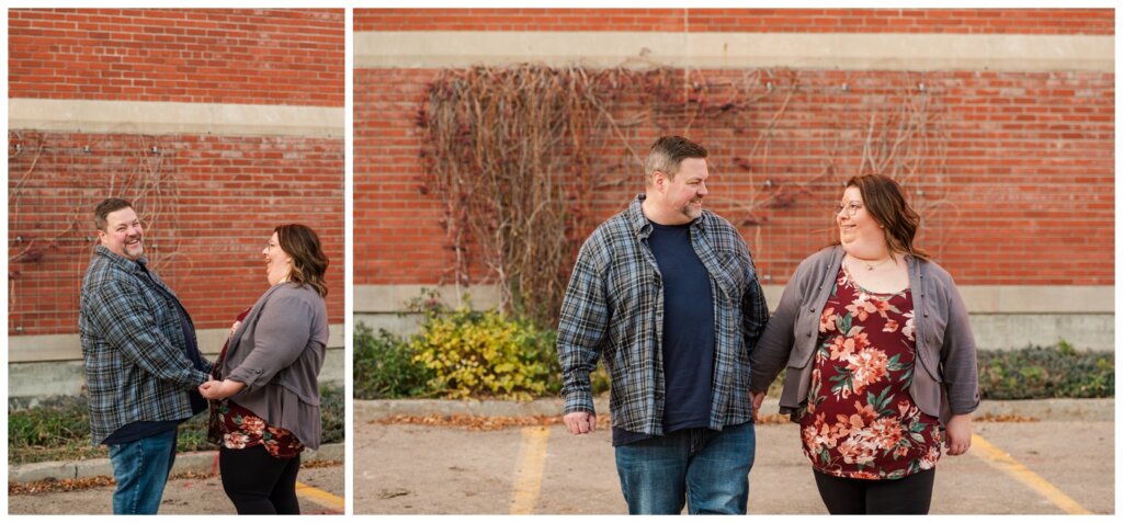 Scott & Ashley - Regina Family Photography - Provincial Archives - 01 - Couple laughs in front of a brick wall