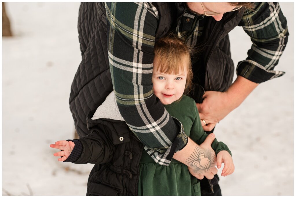 Diacon Family - Winter Family Session - Regina Family Photography - 03 - Dad helps toddler put on her coat