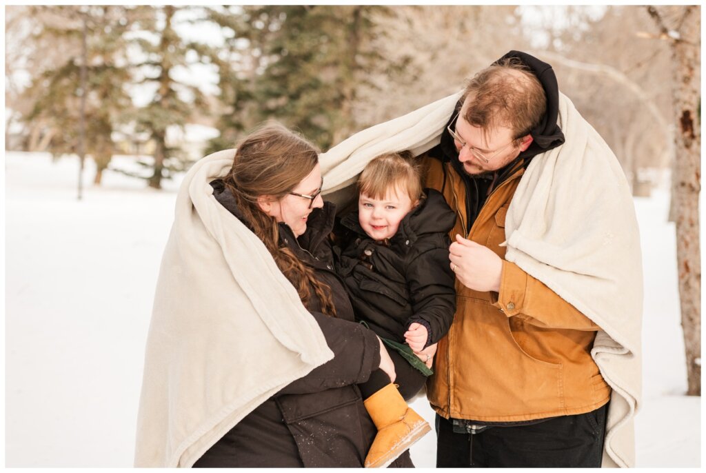 Diacon Family - Winter Family Session - Regina Family Photography - 07 - Family snuggles under fuzzy blanket