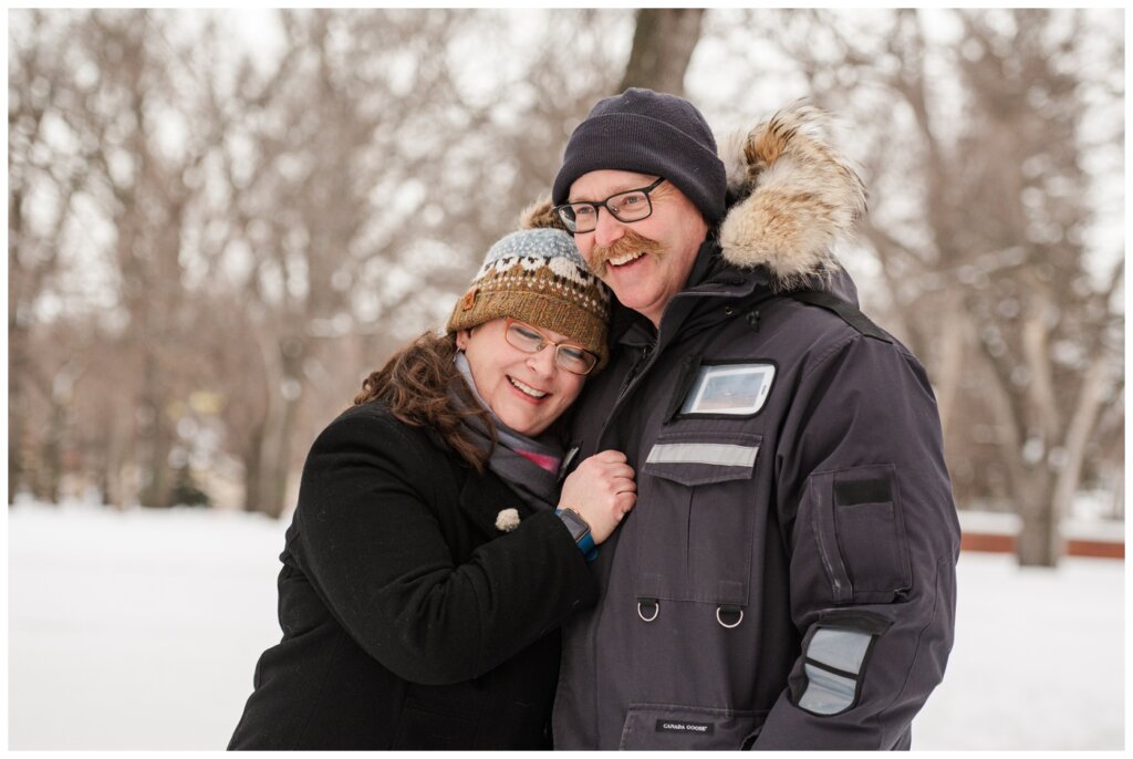 Sheldon & Amy - Regina Winter Photography - Wascana Park - 02 - Wife snuggles into husbands chest