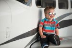 Jace with aviators on a plane at the Regina Flying Club - Favel Family 2015
