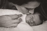 Newborn snuggles and kisses with mom captured by Courtney Liske Photography