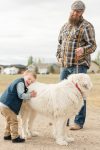 Little boy hugs his white dog Blanche Devereaux