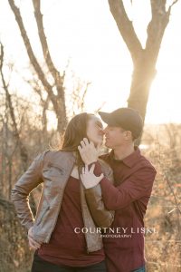 Couple kisses in the Lumsden Valley during their engagement shoot with Courtney Liske Photography