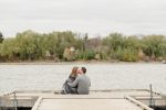 Couple sitting on a dock overlooking Wascana Lake