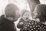 Little boy yawns with mom and dad on a walk in Regina Saskatchewan