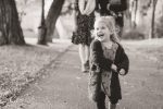 Little girl smiling in large sweater