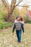 Man gives fiance a piggyback in their Regina engagement session