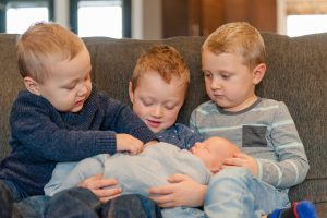 Older brothers with their new baby bro