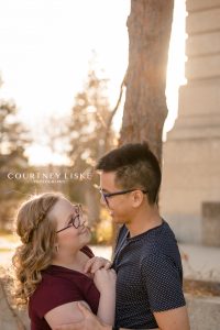 Couple stand together in fall sunlight in Regina