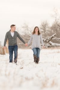 Couple walks hand in hand through the snow