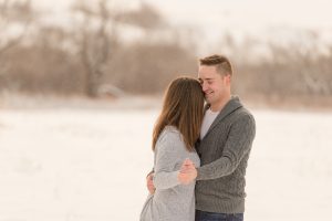 Man and woman dance in open field of snow