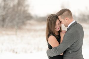 Woman in black dress and man in grey suit in the snow