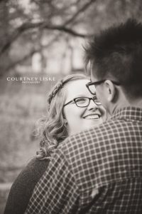 Woman in glasses smiles at her fiancee