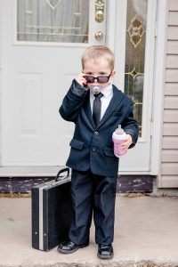 Little boy dressed as Boss Baby