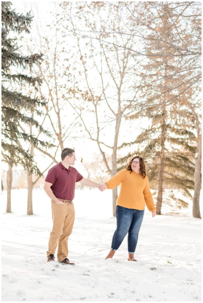 Regina Family Photographer - Goudy Family - Winter Family Session - Snow - Mustard Sweater with Blue Jeans - Candy Cane Park