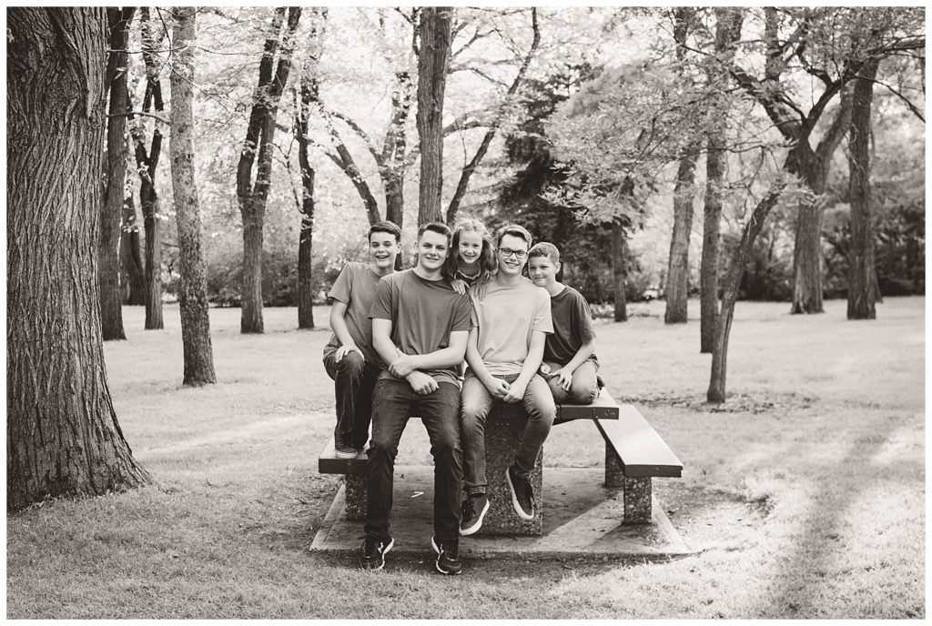 Regina Family Photographers - Butler Family - Caris - Lucas - Aaron - Josiah - Nathan - Wascana Park - Four Brothers sitting with Younger Sister