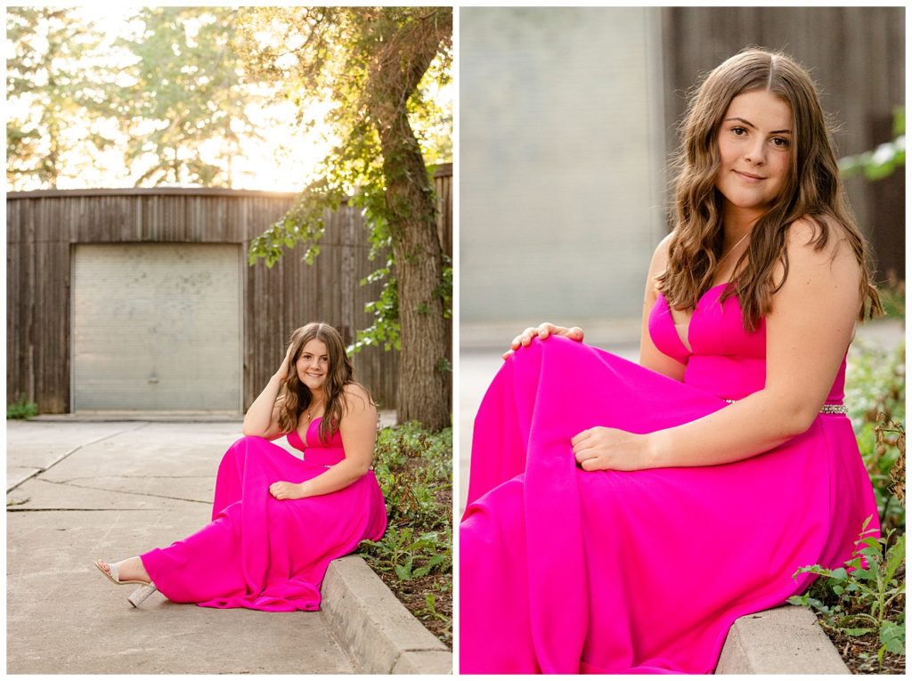 Regina Family Photography - Georgia Graduation 2020 - Summer Graduation Session - Girl in vibrant pink dress sitting on curb near wooden building