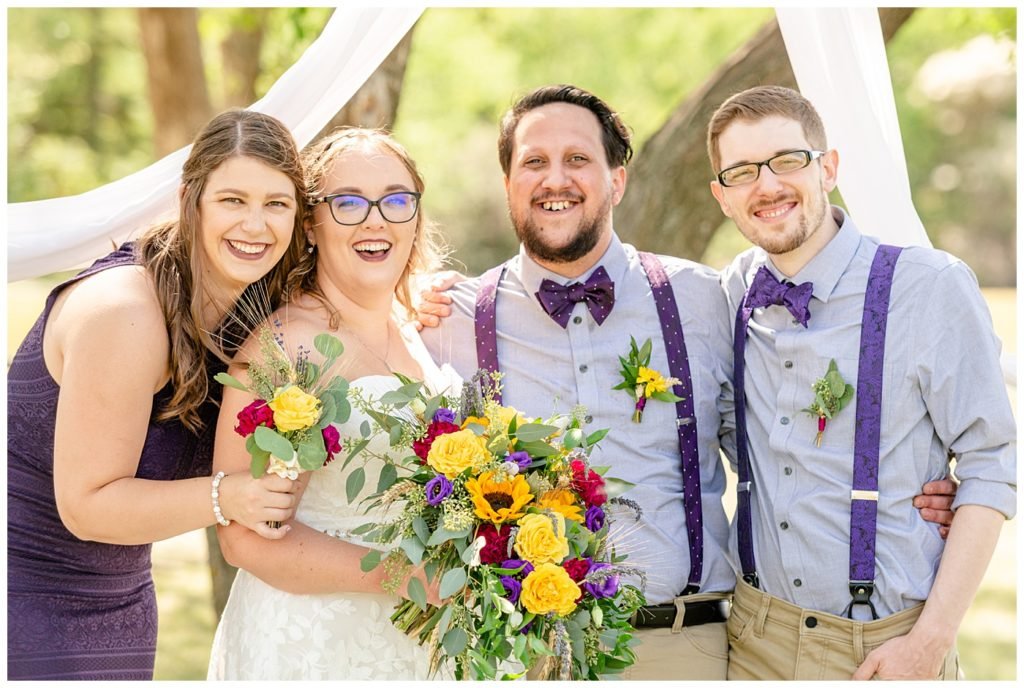 Regina Wedding Photographer - Ryan - Aeliesha - Bridal Party pose together - Bridesmaids purple lace dress - AE Wilson Park