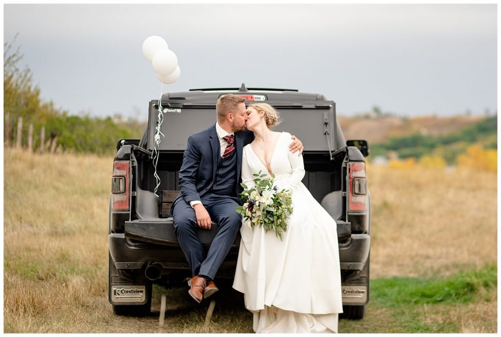 Regina Wedding Photographers - Tyrel - Allison - Groom & Bride in the back of a truck