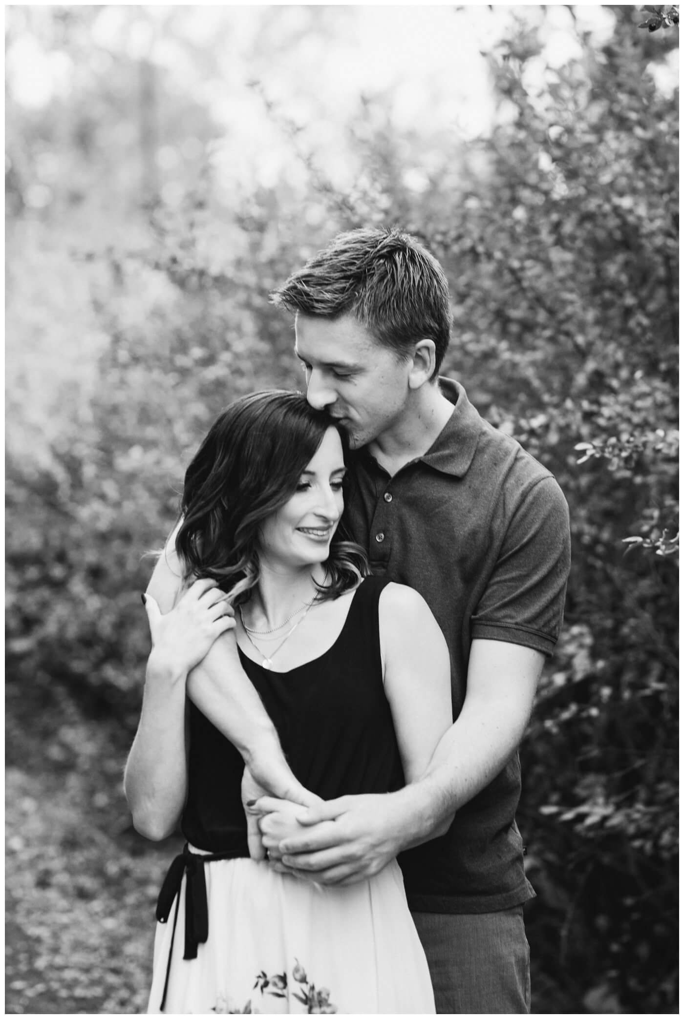 Regina Engagement Photography - Taylor & Jolene - 002 - White City Engagement Session - Black and white kissing forehead