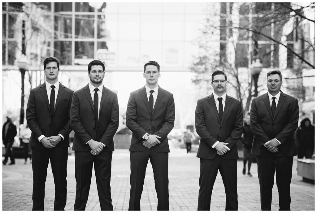 Regina Wedding Photographer - Tim & Jennelle At Home Wedding - Groomsmen serious face on Scarth Street