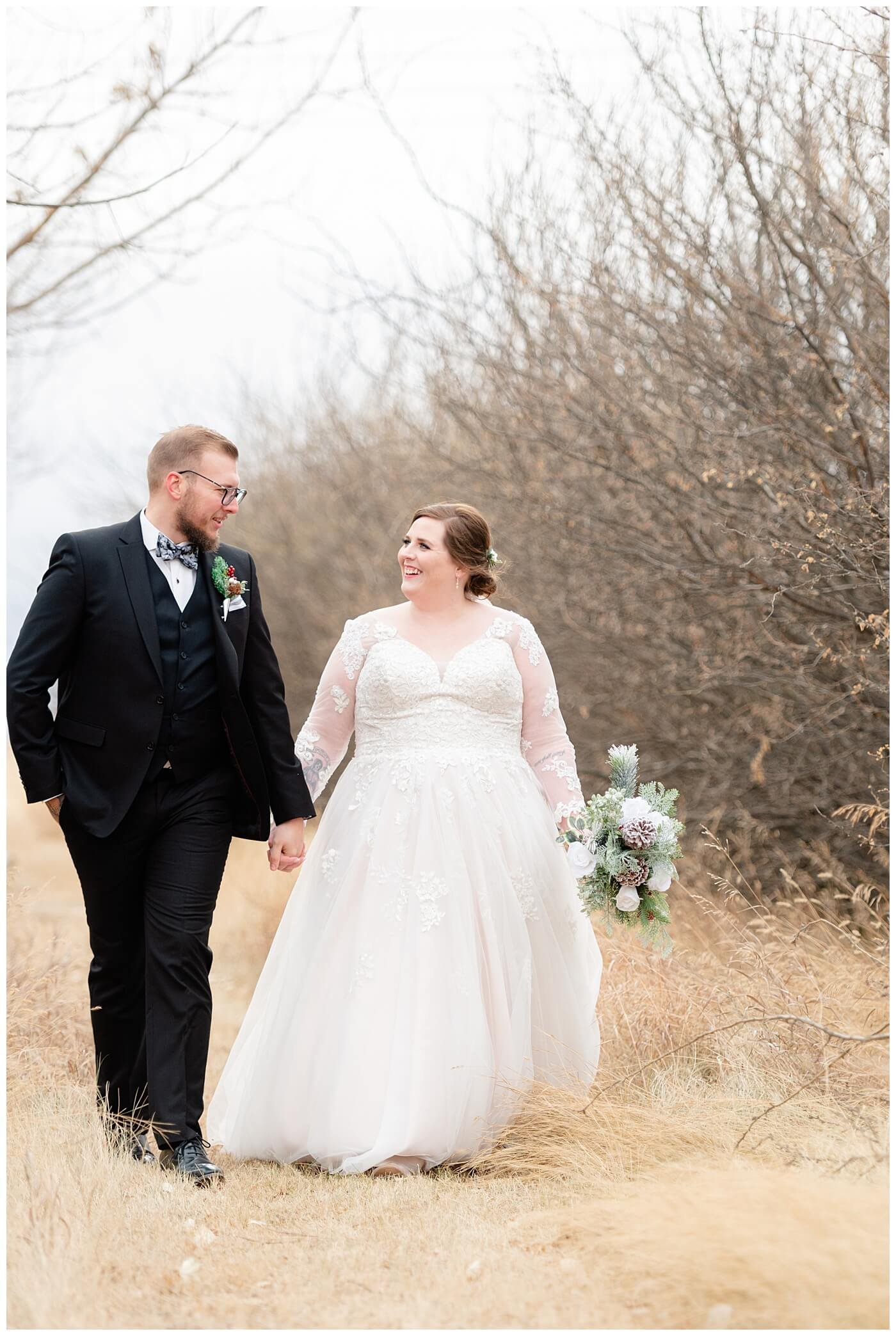 Regina Wedding Photographer - Kolton - Maxine - Bride & Groom walk through tall grass