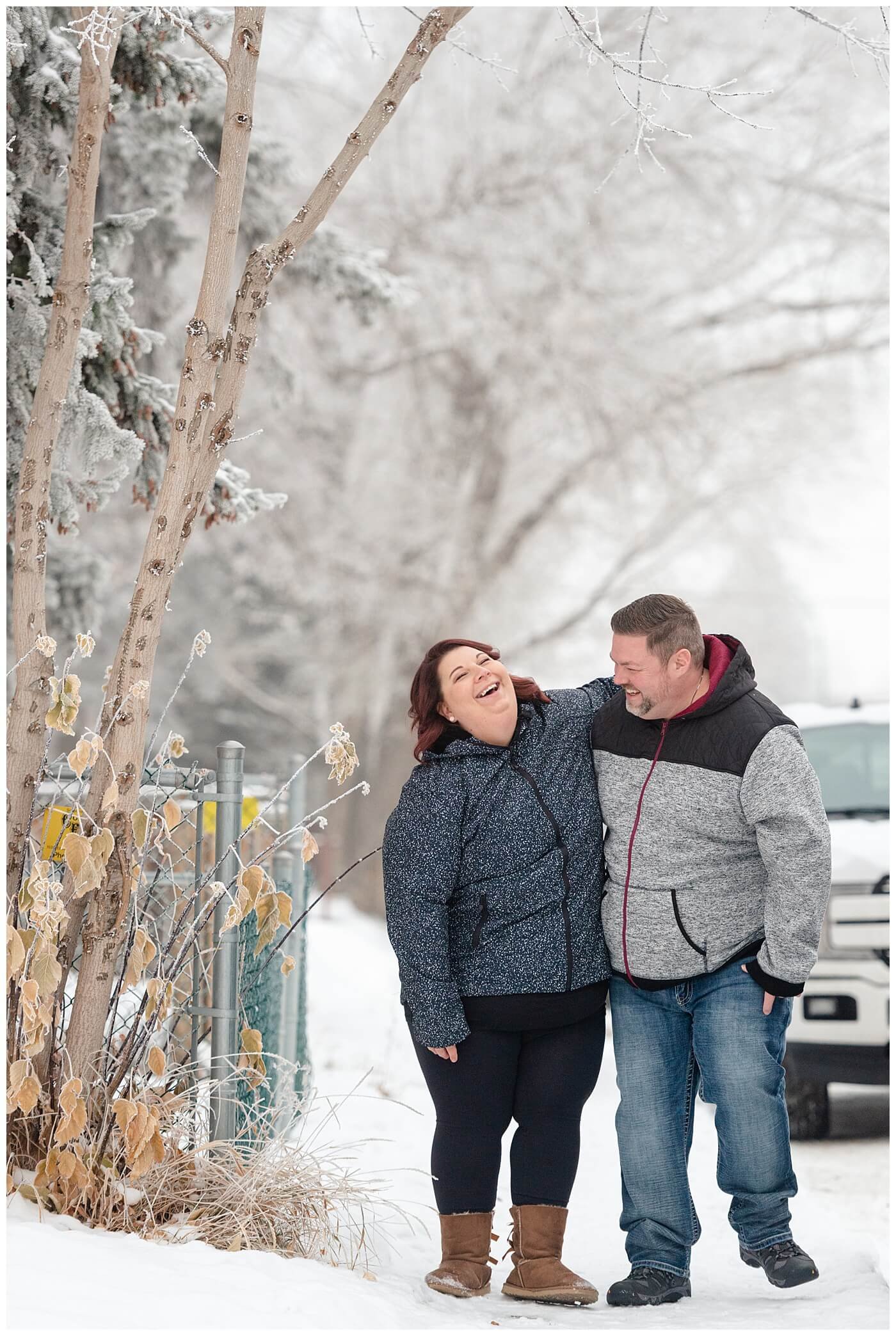 Regina Wedding Photographers - Ashley - Scott - Couple walks down the street together in the snow