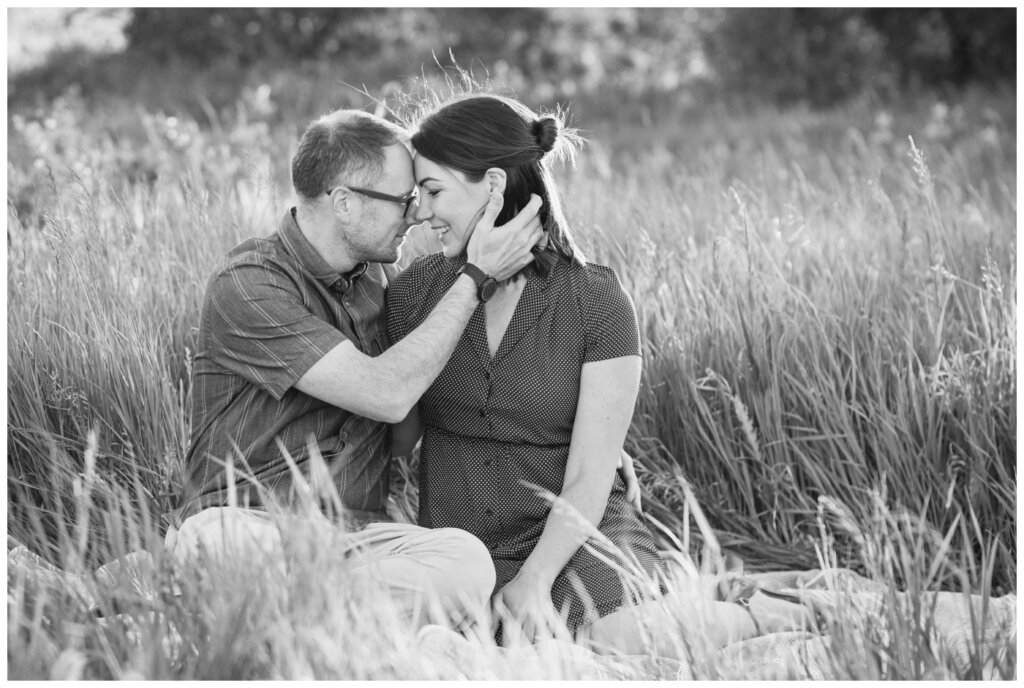 Brent & Courtney -11 - Husband and wife in embrace in grass