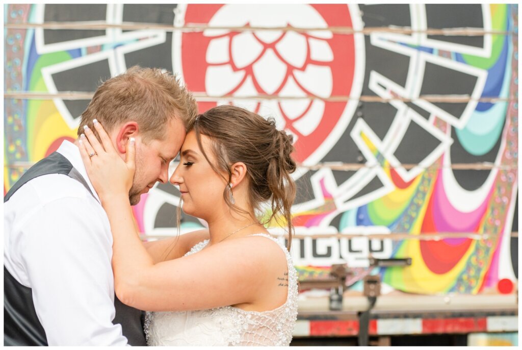 Jon & Callie - 21 - Bride and Groom Outside of Rebellion Brewing Company