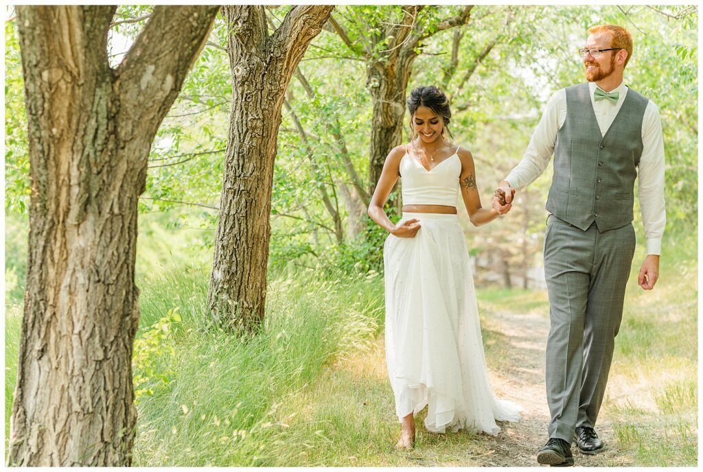 Stephen & Sarah Wedding - 14 - Bride & Groom strolling near the Saskatchewan Science Centre