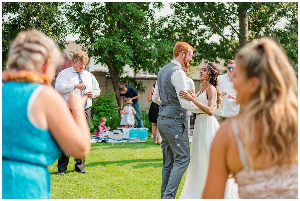 Stephen & Sarah Wedding - 21 - Bride & Groom first dance in backyard with bubbles