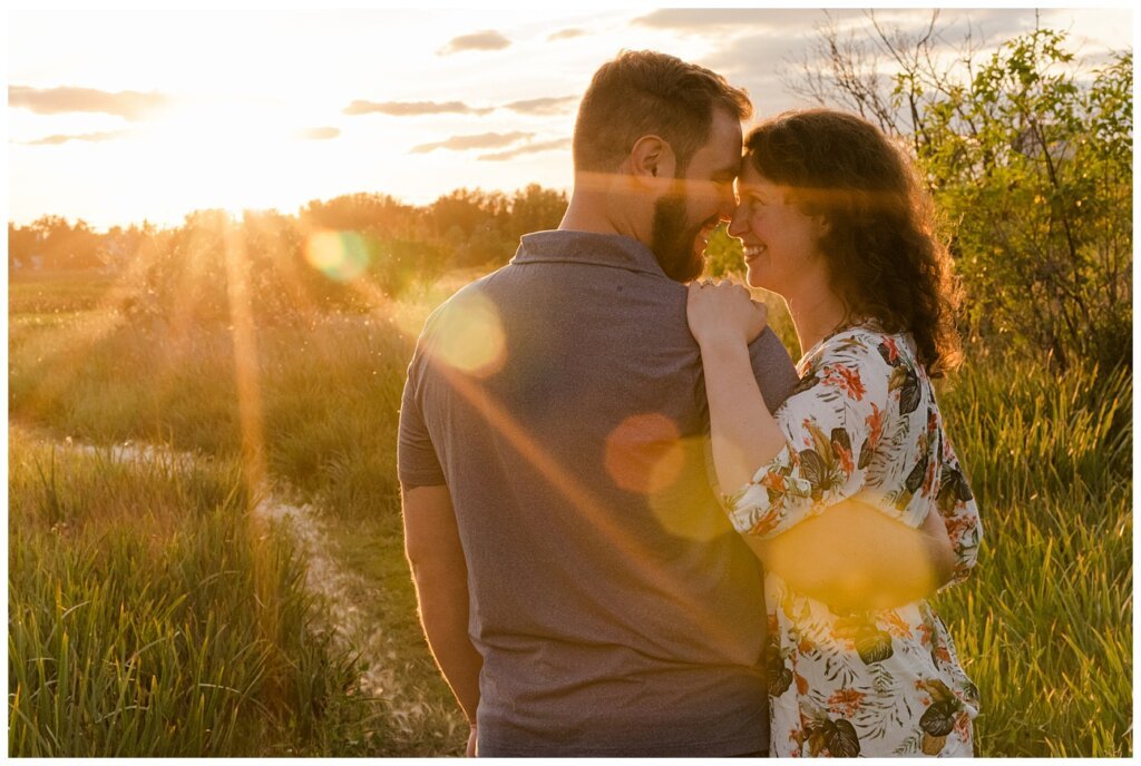 Mitch & Val - Engagement Session in Wascana Habitat Conservation Area - 09 - Couple with sunflare at sunset