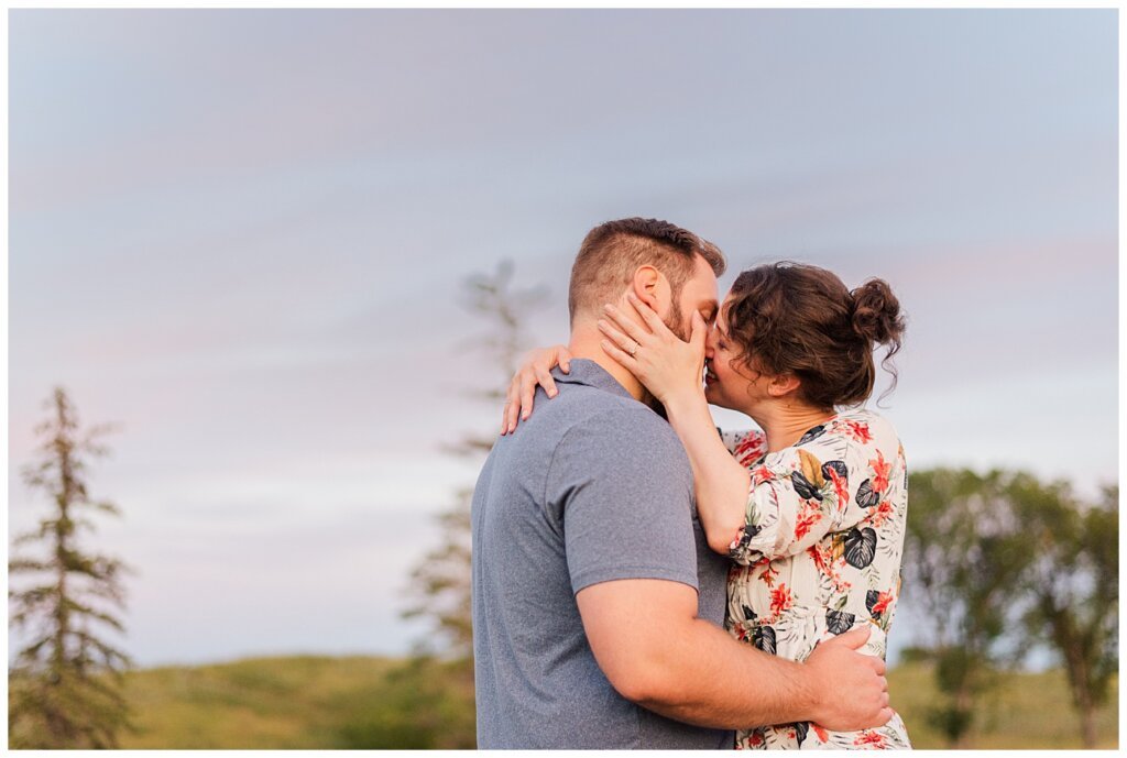 Mitch & Val - Engagement Session in Wascana Habitat Conservation Area - 13 - Couple going in for a giggling kiss